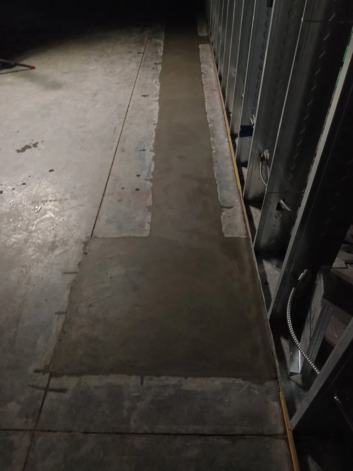 Night commercial concrete and utility trenching work under lights by Lucky's Concrete