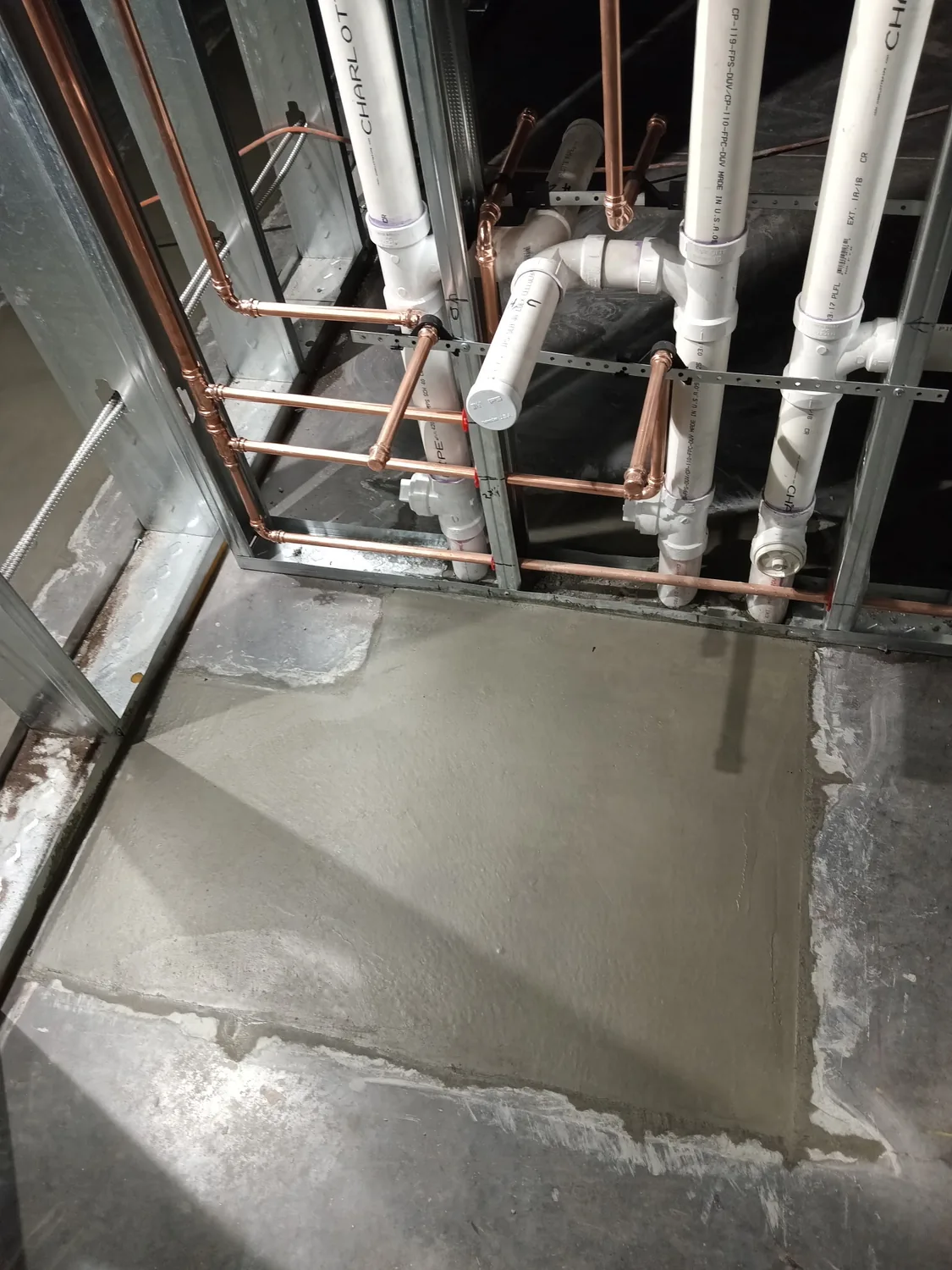 Night commercial concrete pour and finishing under work lights by Lucky's Concrete